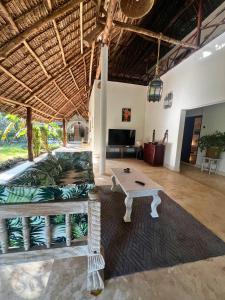 a living room with a couch and a table at Mepoho Beach Villa Watamu in Watamu