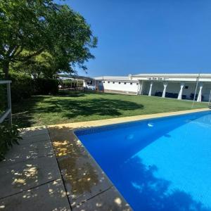 a swimming pool in the yard of a house at Casa Monte da Eira in Giões