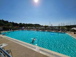 a person swimming in a large swimming pool at Sea Diva - luxury boathouse in Portorož