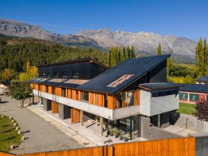 an aerial view of a house with a black roof at ENTREVERDES Departamentos in El Bolsón