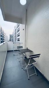 a balcony with tables and chairs on a building at Haven Hub in Abu Dhabi