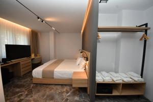 a hotel room with a bed and a television at Giulia Center Hotel in Tirana +94 photos