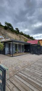 a building with a deck with benches on it at Complex Turistic Emilio in Sviniţa +29 photos
