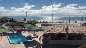 a resort with a swimming pool and a beach at Pousada beira mar e sol in Tibau +10 photos
