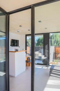 an open kitchen and living room with sliding glass doors at ENTREVERDES Departamentos in El Bolsón
