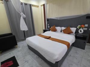 a bedroom with a large bed in a room at The alder hotel and accommodation in Bungoma