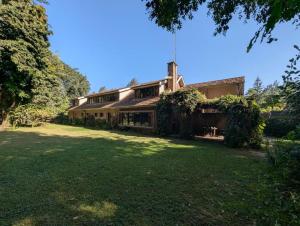 a house with a large yard in front of it at The Researchers Rest in Arusha +10 photos