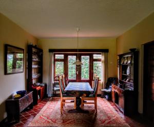a dining room with a table and chairs at The Researchers Rest in Arusha