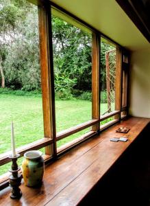 a window in a room with a view of a field at The Researchers Rest in Arusha