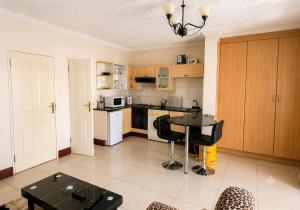 a kitchen with a table and a counter top at Deluxe Studio Suite with Kitchenette in Gaborone