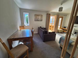 a living room with a table and a couch at Terling House in Hythe