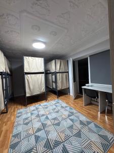 a room with a ping pong table and a rug at Ho5tel House in Shymkent +8 photos