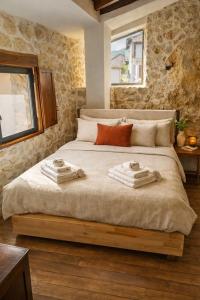 a bedroom with a large bed with towels on it at CASA DI Noris in Fiuggi