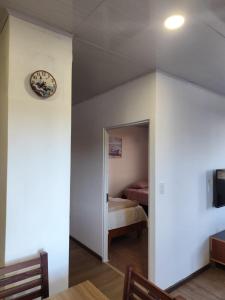a room with a bedroom with a bed and a mirror at Refugios del Pescador in San Cristóbal