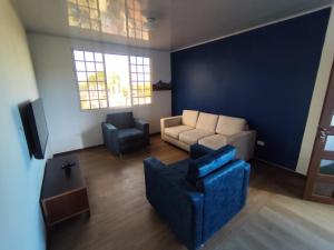 a living room with a couch and a chair at Refugios del Pescador in San Cristóbal +6 photos