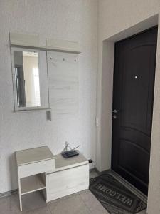a room with a desk and a door and a mirror at Апартаменти біля чорноморського моря in Fontanka
