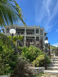a large building with a palm tree in front of it at Lavista Antigua in Bats Cave