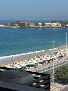 a view of a beach with umbrellas and people at Studio miguel II in Rio de Janeiro