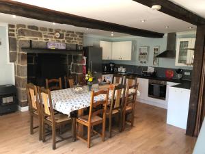 a kitchen with a table with chairs and a fireplace at Hill Crest Gite in Vengeons