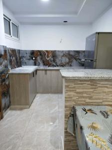 a kitchen with a counter and a counter top at Appartement lemjid in Kelibia