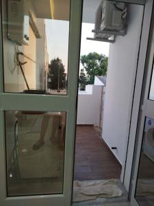 a view through a glass door into a hallway at Appartement lemjid in Kelibia