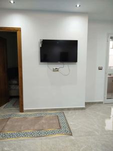 a wall with a flat screen tv on a white wall at Appartement lemjid in Kelibia