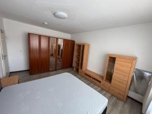 a room with a bed and wooden cabinets at Landshuter str 17 in Straubing