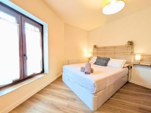 a bedroom with a bed and a large window at Apartamento Casa Blanca in Tramacastilla de Tena