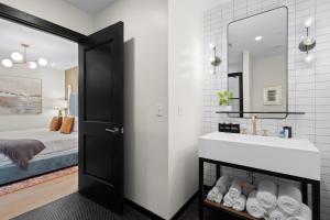 a bathroom with a sink and a mirror at Eleven48 Hotel in New Orleans +187 photos