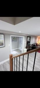 a room with a staircase and a living room at BASEMENT APARTMENT Two Bedrooms in Whitby