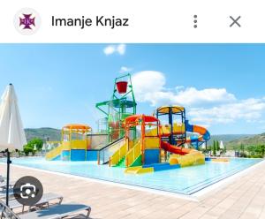 a pool with a water park with a water slide at Prolink Residence Podgorica in Podgorica