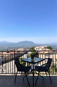 a table and chairs on a balcony with a view at Panorama Rooms in Gesualdo