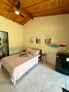 a bedroom with a bed and a flat screen tv at Hospedagem Ratzke in Paraty +12 photos
