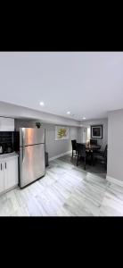 a living room with a kitchen and a dining table at BASEMENT APARTMENT Two Bedrooms in Whitby