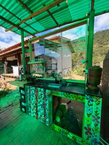 a patio with a glass counter with a sink at Hospedagem Ratzke in Paraty