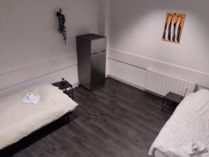 a room with a bed and a dresser in it at Le Lilas - 6 in Cherbourg en Cotentin
