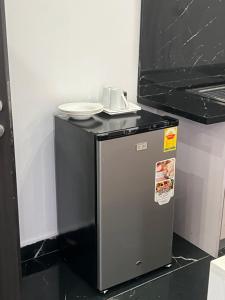 a small refrigerator with a plate on top of it at Afse apartments Peduase in Aburi
