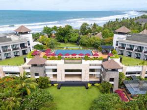 an aerial view of a resort with a pool and the ocean at Pullman Bali Legian Beach in Legian