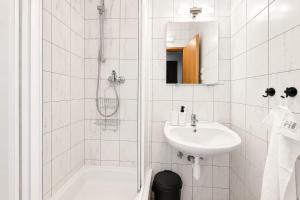 a white bathroom with a shower and a sink at Rennerka Horská bouda in Strážné +29 photos