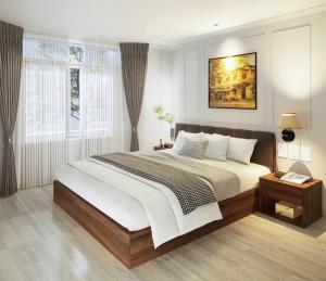 a bedroom with a large bed and a window at Boutique KAS Luxury Hotel in Ho Chi Minh City +38 photos