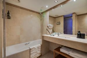 a bathroom with a bath tub and a sink and a bath tub at Penthouse Duplex with Epic Views in Barcelona +56 photos
