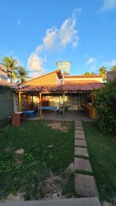 a building with a table in the yard at Acomodações as casinhas da ada in Coruripe