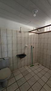 a bathroom with a toilet and a sink at Acomodações as casinhas da ada in Coruripe +28 photos