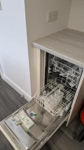 a dishwasher with dishes in it under a counter at The Annexe in West Buckland +3 photos
