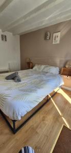 a large bed in a room with at Chez T-E-O in Cognac