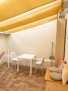 a living room with a white table and chairs at Cozy Studio in Szentendre