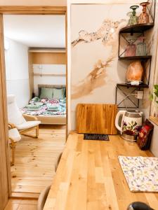 a living room with a table and a bed at Cozy Studio in Szentendre