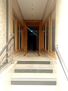 a hallway of a building with stairs and a door at la Casa de doha in Tangier