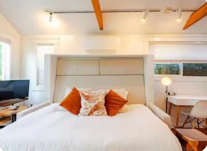 a bedroom with a large white bed and a desk at Star Studio, A Garden Retreat near University of Oregon in Eugene