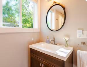 a bathroom with a sink and a mirror at Star Studio, A Garden Retreat near University of Oregon in Eugene +14 photos